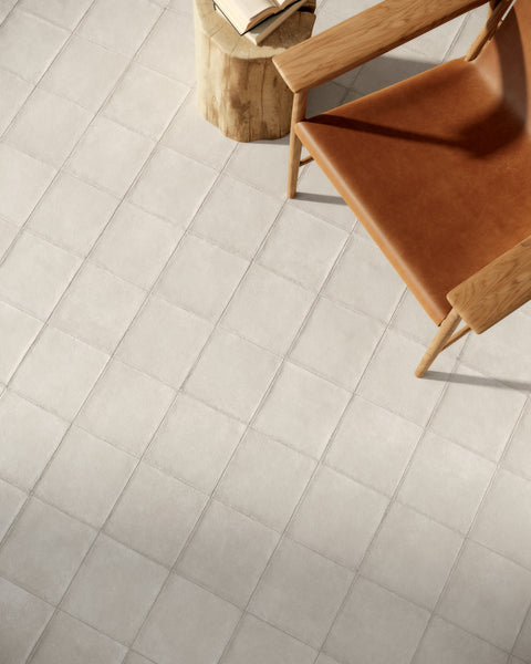 Craft Chalk tiles with a timber chair in a warm interior